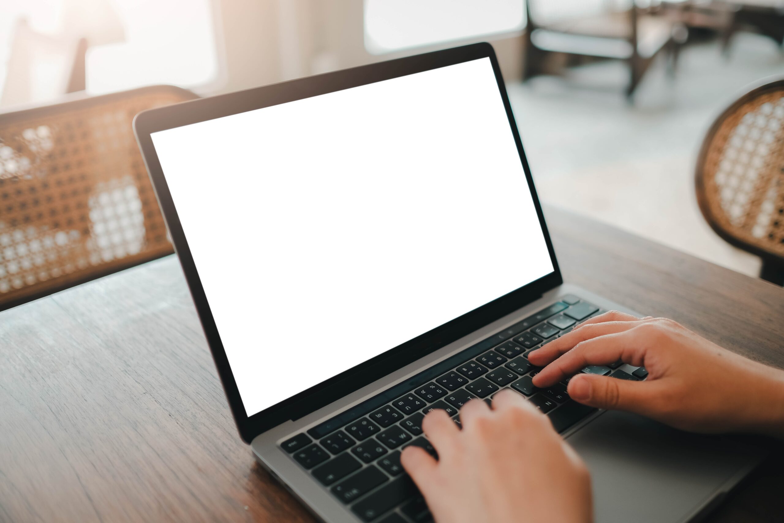 Person's hands typing on laptop keyboard