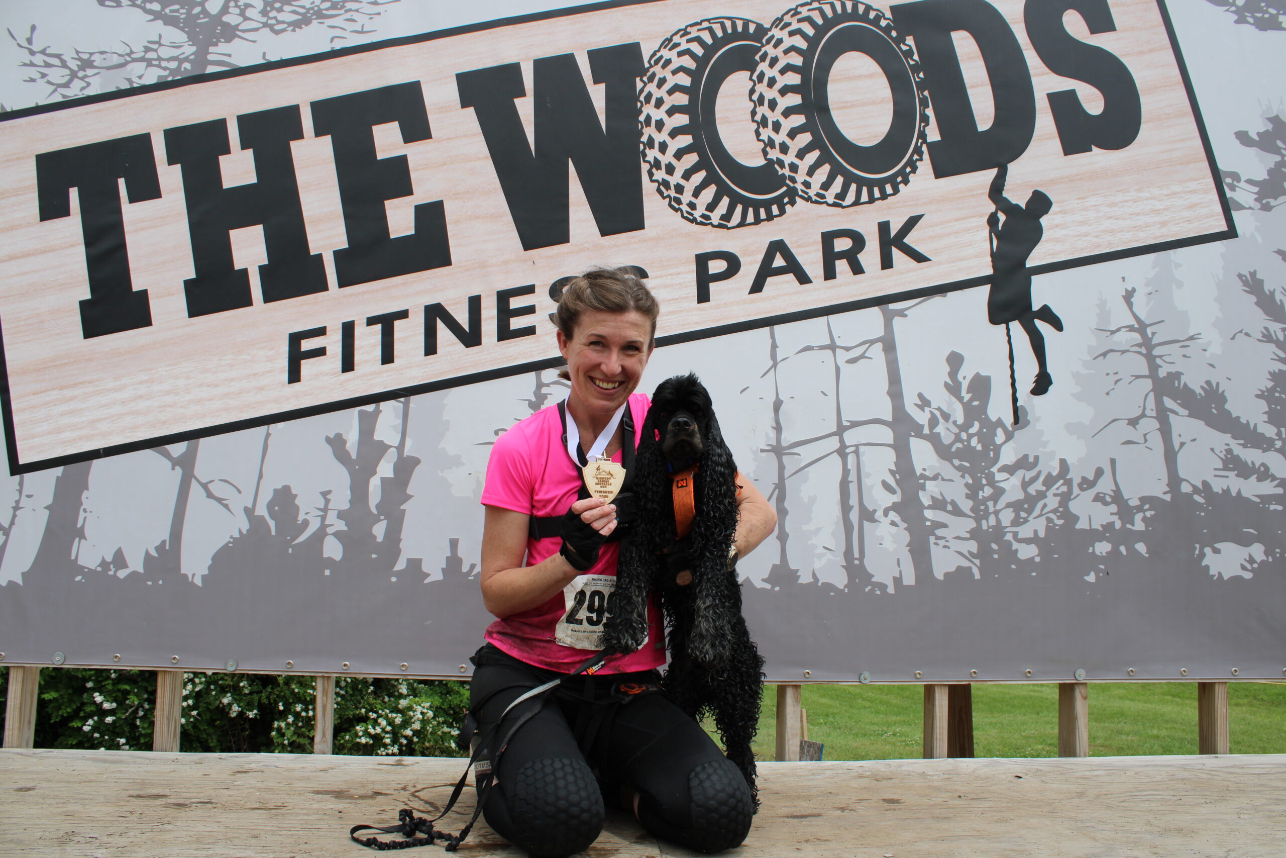 Jaime and Luigi pose with their medal after completing an obstacle course race