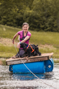 Jaime pulling herself and Luigi on a raft over a water crossing