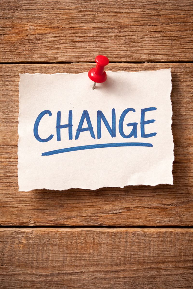 Paper with the word "change" tacked to a wooden board